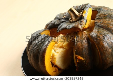 Close up photo of pumpkin pudding menu put on the black plate on light brown background
