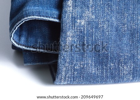 Blue denim jeans in bright color in the scene present the old denim look and old damaging fabric that shown detail of texture background