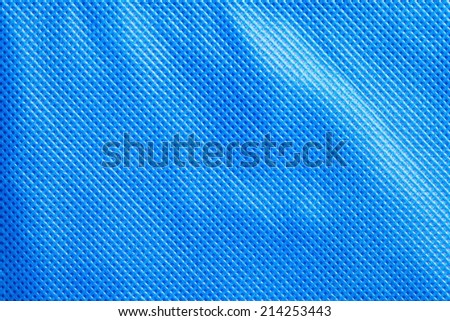 Close up photo of artificial leather surface texture in light blue color to show the texture pattern and detailing of material.