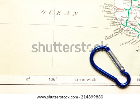 Old  and vintage paper map  with key holder snap link style putting on it represent the detail of city name and destination.