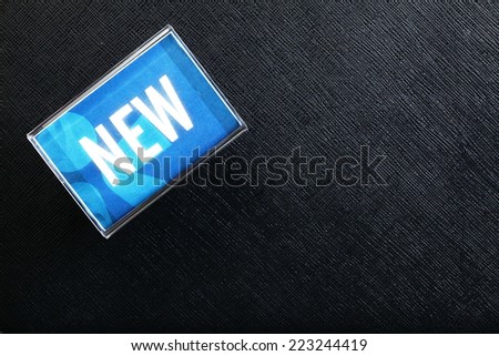 Acrylic stand with the word new represent as a sign display for customer to know the new products