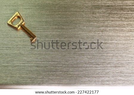 A small golden chrome color key put on the chrome aluminum plate surface represent the abstract meaning.