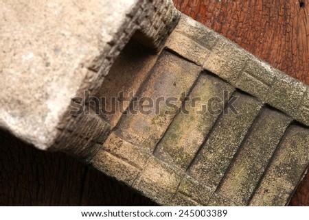Old and vintage surface texture of sand stone pavilion stair architectural sculpture model with moss stain represent the texture and surface background.