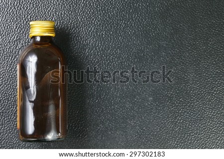 Brown color bottle with gold color metal lid represent the medicine containing bottle concept related idea.