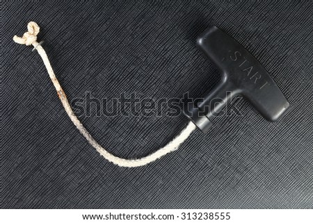 Dirty and broken pull start rope represent the tools and equipment concept related idea.