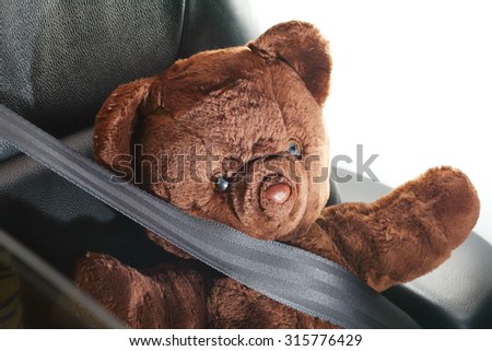 The bear doll in action of fall down the head to the car steering represent the car accident concept related idea.