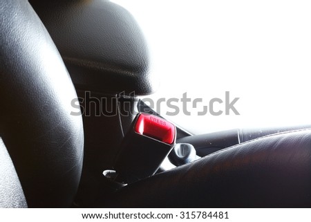 The safety belt equipment at the black color car seat represent the car safety part concept related idea.