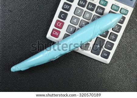 The wrapped plastic model plane put beside calculator represent the model toy plane and plane color painting service business concept related idea.