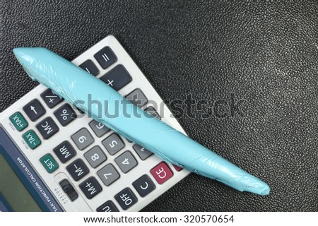 The wrapped plastic model plane put beside calculator represent the model toy plane and plane color painting service business concept related idea.