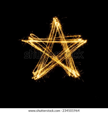 Sparkler firework light with star shape isolated on black background.