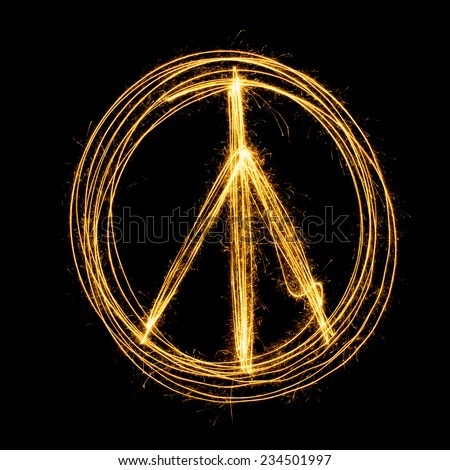 Sparkler firework light with peace sign isolated on black background.