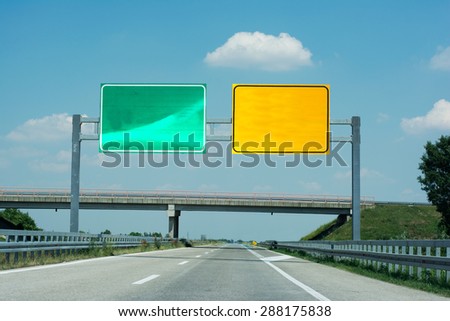 Boards on high way yellow and green for directions