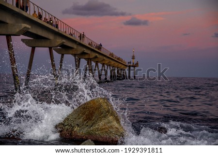Similar – Image, Stock Photo Sunset sky over wavy sea with floating boats