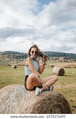 Similar – Foto Bild Ländliches Feld unter bewölktem Himmel mit Sonnenstrahlen