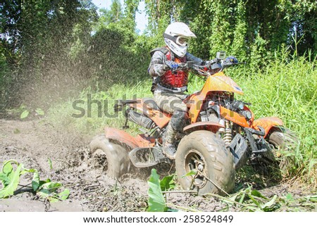 CHIANG MAI, THAILAND - OCTOBER 19 : Tourists riding ATV to nature adventure on dirt track on OCTOBER 19, 2014 in Chiang Mai, Thailand.