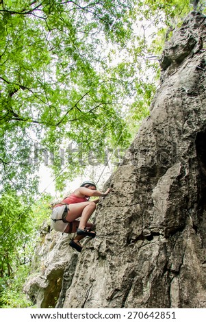CHIANG MAI, THAILAND - July 3, 2014 : Young people rock climbing on a limestone wall with adventure for tourist in Chiang Mai, Thailand.