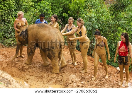 CHIANG MAI, THAILAND - JUNE 26, 2015 : Tourist playing mud with elephant in Chiang Mai, Thailand.