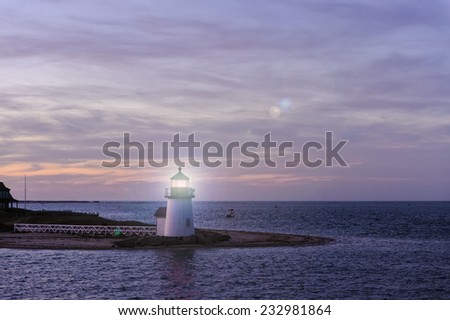 Brant Point Lighthouse during the blue hour just after sunset. Brant Point light house, at the entrance to Nantucket Harbor, Cape Cod, Massachusetts, is the shortest lighthouse in New England.