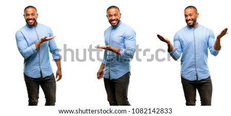 African american man with beard holding something in empty hand