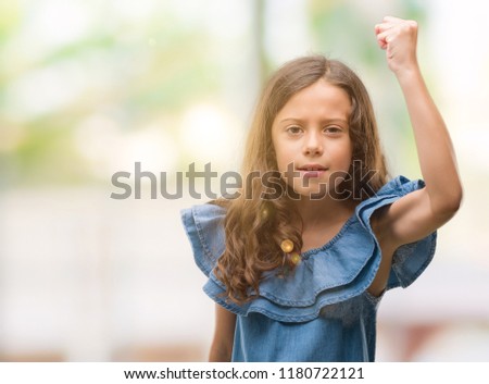 Brunette hispanic girl wearing denim dress annoyed and frustrated shouting with anger, crazy and yelling with raised hand, anger concept