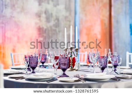 classy elegant table Wedding hall, eve or dinning or other function facility with colorful ceiling lights set for fine dining