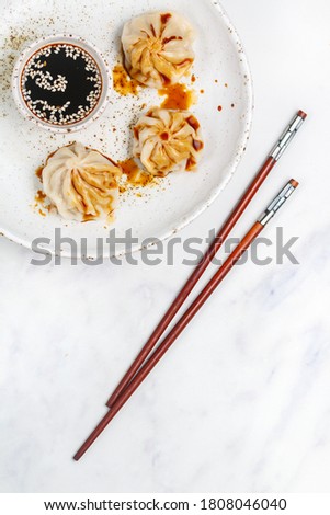 Dumplings with meat or seafood (pork, beef, fish, shrimp) with soy sauce and sesame seeds. Eastern and Asian dishes (Chinese, Korean, Japanese, Vietnamese, Thai).  Selective focus, copy space