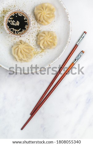 Dumplings with meat or seafood (pork, beef, fish, shrimp) with soy sauce and sesame seeds. Eastern and Asian dishes (Chinese, Korean, Japanese, Vietnamese, Thai).  Selective focus, copy space