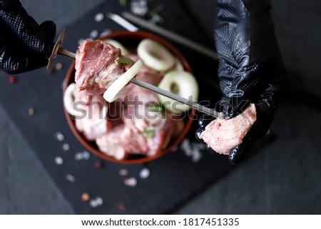 Raw meat slices with onions. Cooking kebabs. Defocus sea salt. Grilled meat. Macro.