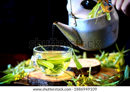 Selective focus. Linden tea, teapot, linden leaves. Linden tea making concept.