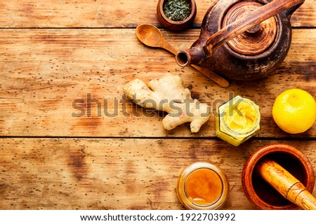 Teapot with tea made from ginger,honey and lemon.Healthy ginger tea with lemon