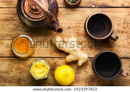 Teapot with tea made from ginger,honey and lemon.Vitamin, healing tea