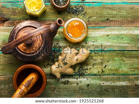 Teapot with tea from ginger,honey and lemon.Vitamin, healing tea.Space for text