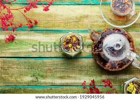 Fragrant flower tea in a glass teapot.Space for text