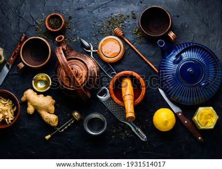 Teapot with ginger tea and honey.Vitamin,healing tea.Healthy ginger tea with lemon.Alternative medicine