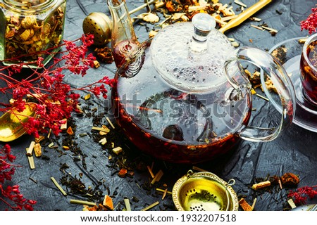 Fragrant flower tea in a glass teapot