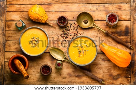 Autumn vegetarian pumpkin cream soup.Pumpkin soup on wooden rustic table