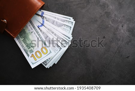 Money in brown wallet