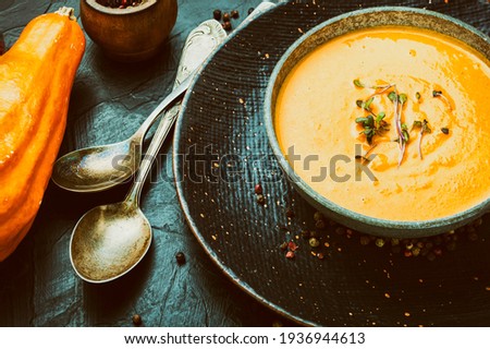 Vegetarian pumpkin cream soup.Bowl of autumn vegan pumpkin soup.