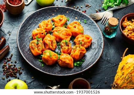 Steamed dumplings or manti with pumpkin.Traditional autumn dish.