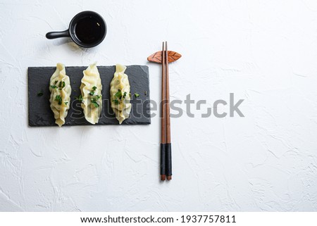 Japanese gyoza or dumplings snack with soy sauce Asian food on white background with space for text. lay flat top view