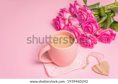 Morning coffee with a beautiful bouquet of roses. Romantic breakfast concept, wooden hearts, festive good mood. Pastel pink background