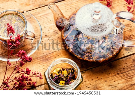 Glass teapot and cup with flower tea