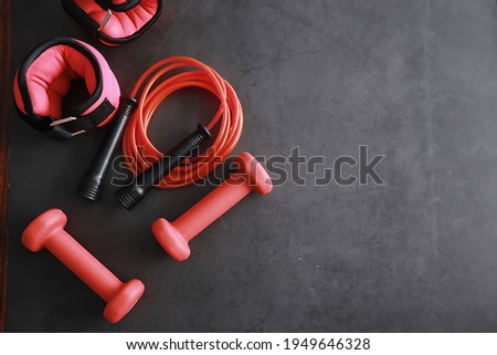 Sport and healthy lifestyle. Accessories for sports. Yoga mat dumbbell and jump rope. Sports background with home exercises concept. Photo stock © 