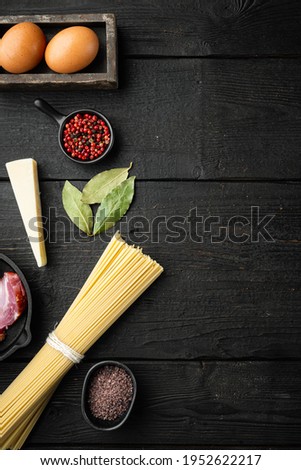Ingredients for Pasta Carbonara. Traditional Italian food set, on black wooden background, top view flat lay, with copy space for text