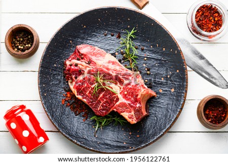 Raw beef meat with rosemary and spices