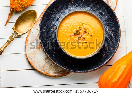 Autumn vegetarian pumpkin cream soup.Pumpkin and carrot soup.Dietary food