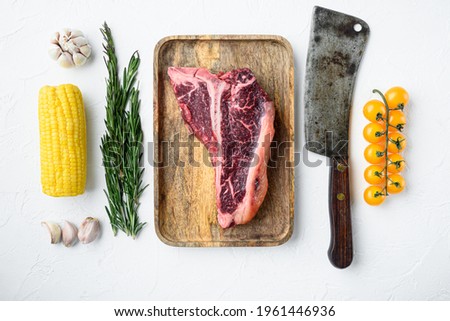Italian Florentine T-bone beef meat Steak with herbs set, on white stone background, top view flat lay