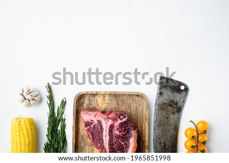 Big raw porterhouse steak with spices and ingredients set, on white stone background, top view flat lay, with copy space for text