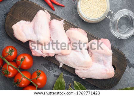 Sticky wings ingredients set, and sesame, on wooden cutting board, on gray background, top view flat lay