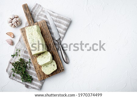 Dairy green butter with herbs set, on white stone background, with copy space for text